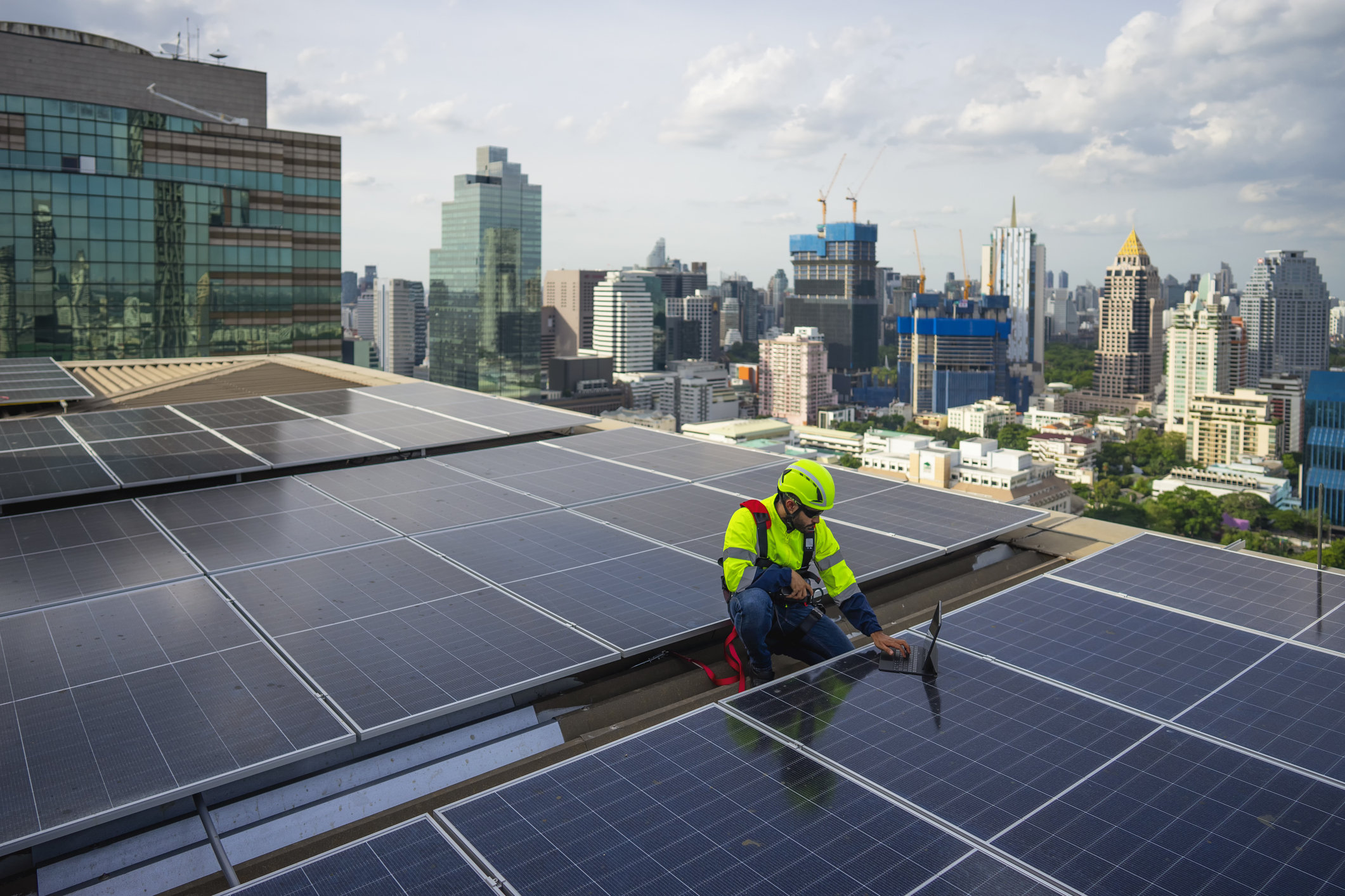 solar panel electrician working on solar panels on building
