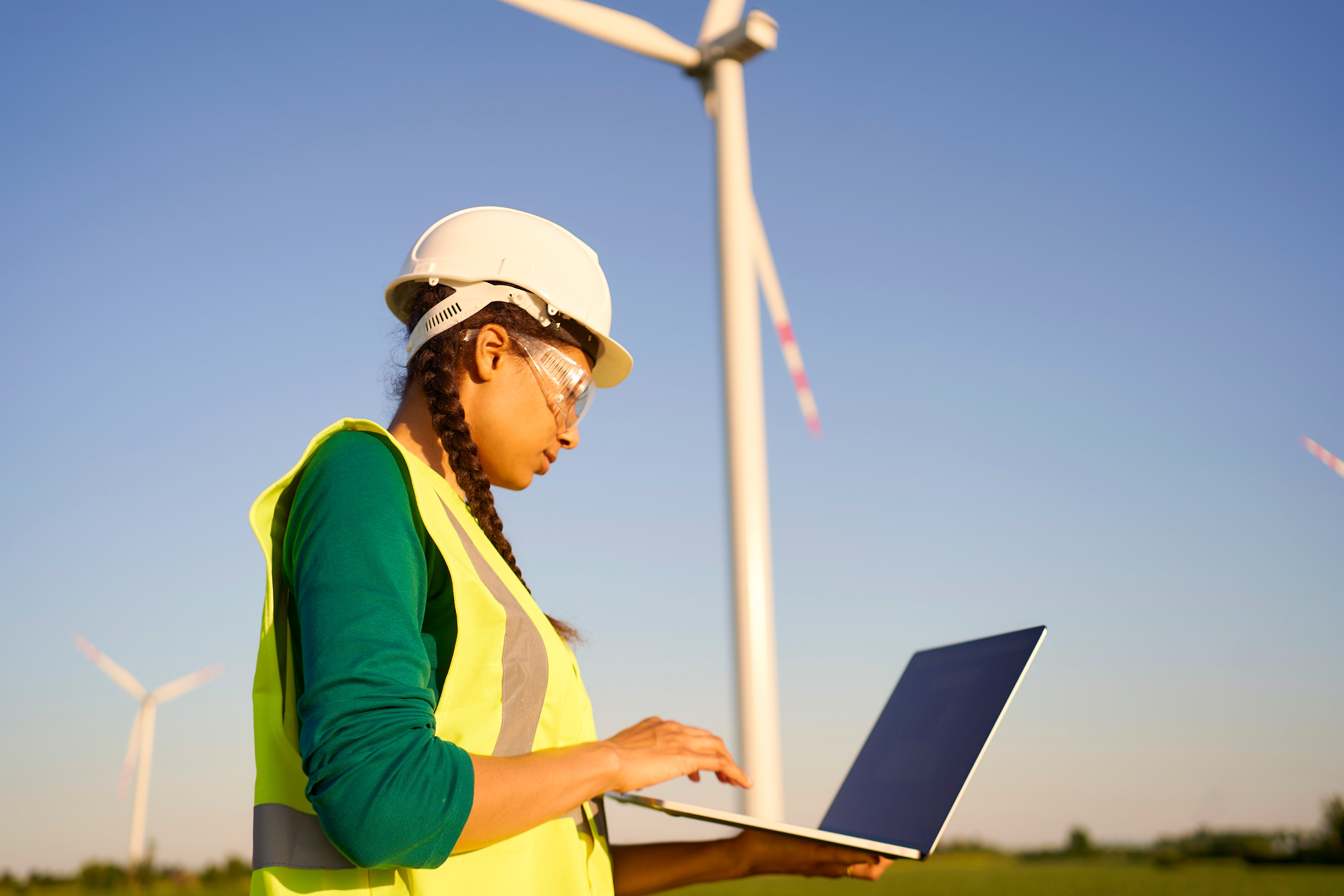 Female engineer setting up wind turbine