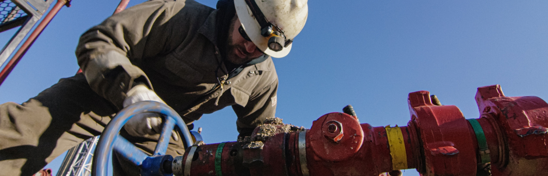 An engineer tightening up a valve in pipework