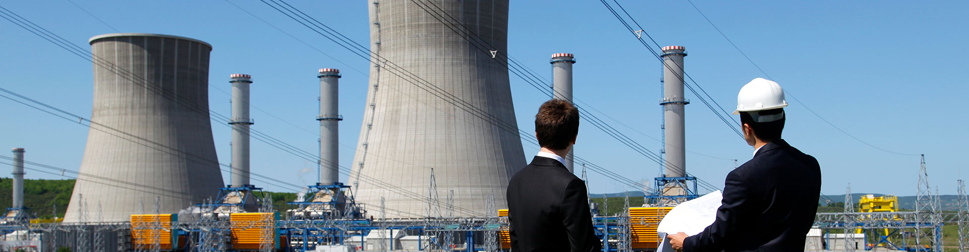 Two people looking towards a nuclear plant