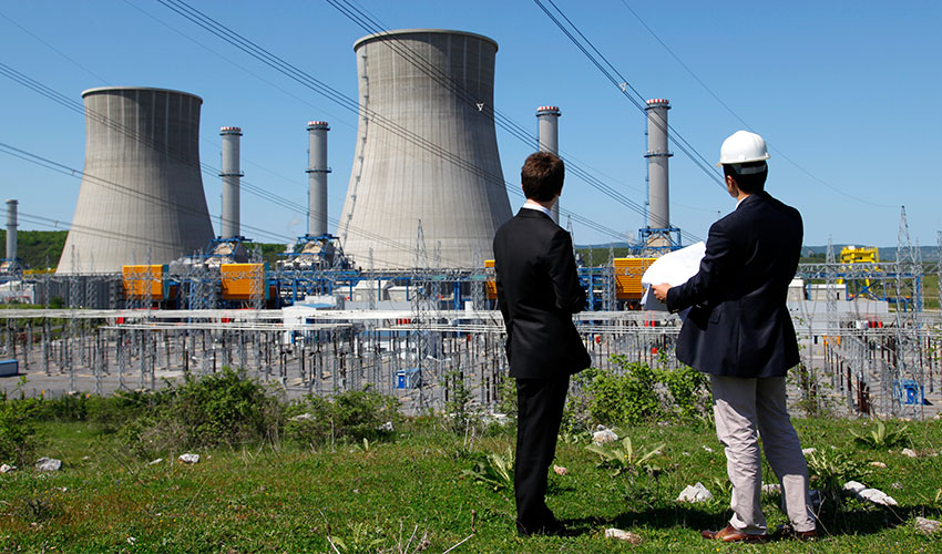 Two people looking towards a nuclear plant