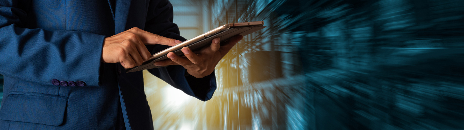 A man with a tablet in a data centre