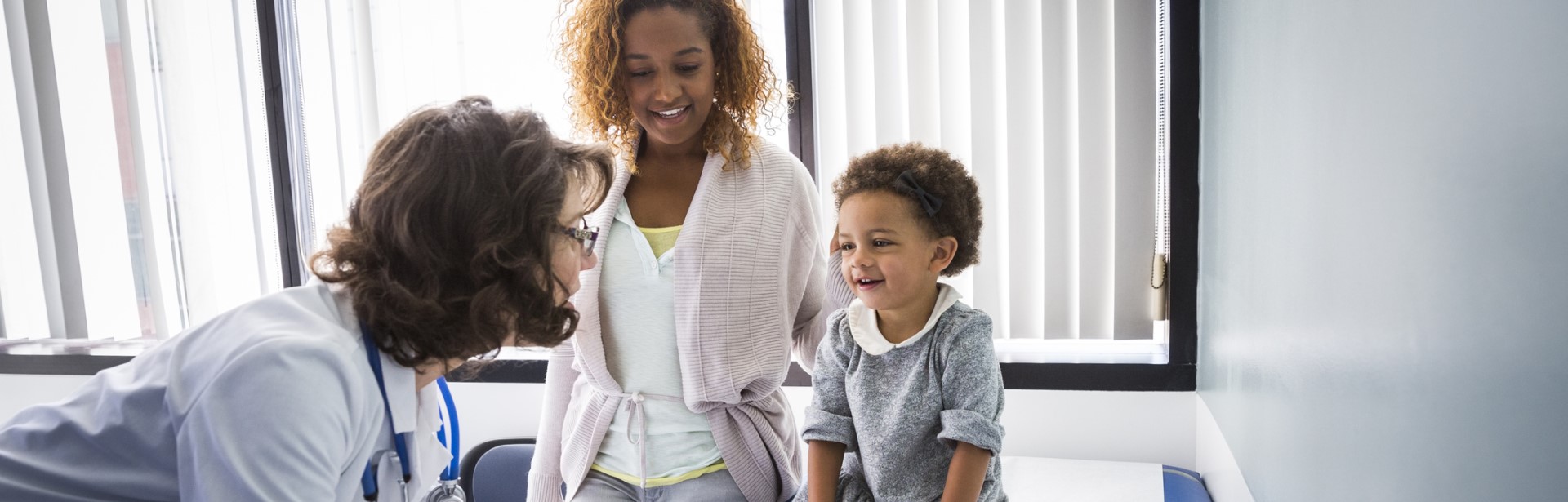 doctor attending to child and parent