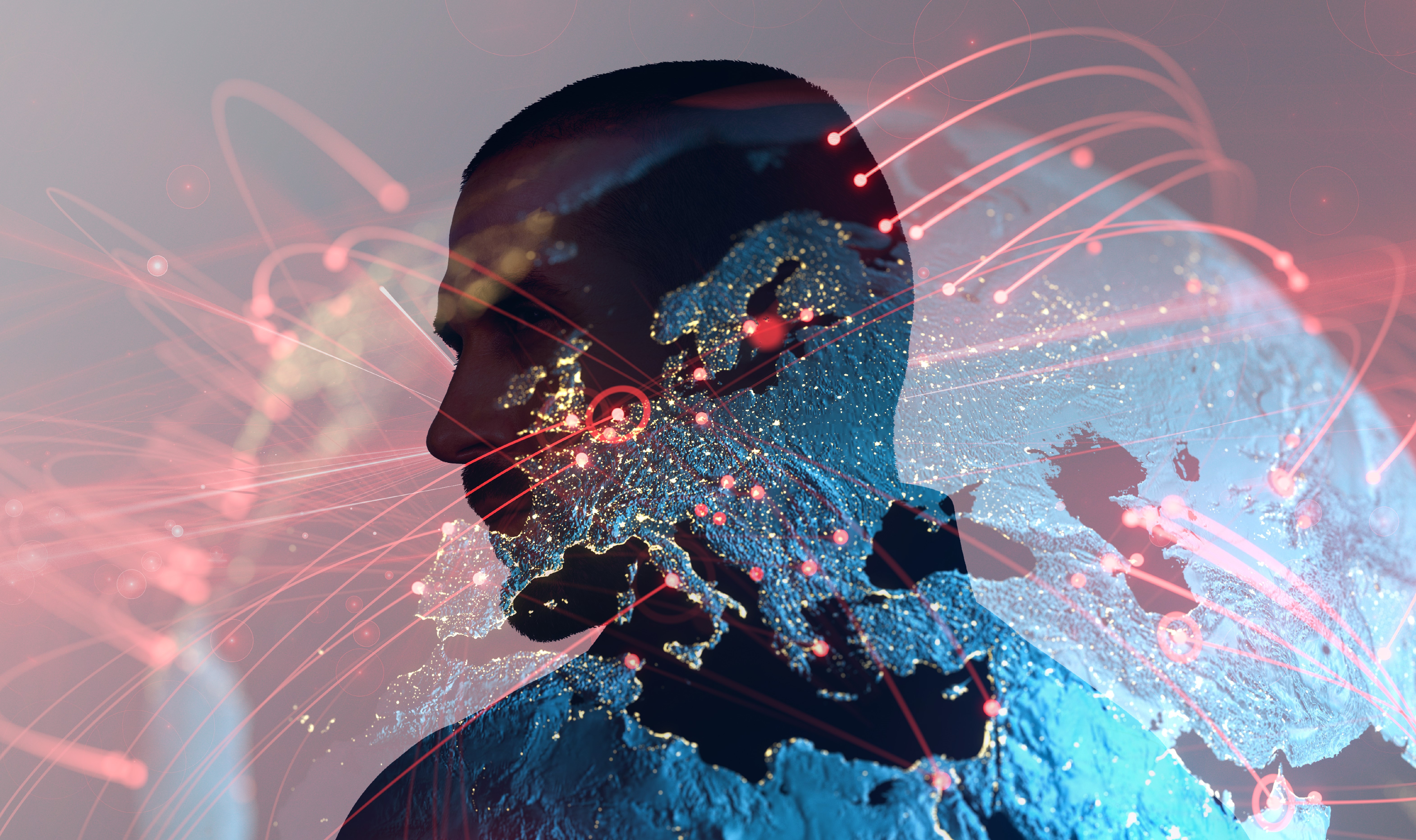 The silhouette of a man's head superimposed over the Earth lit up at night