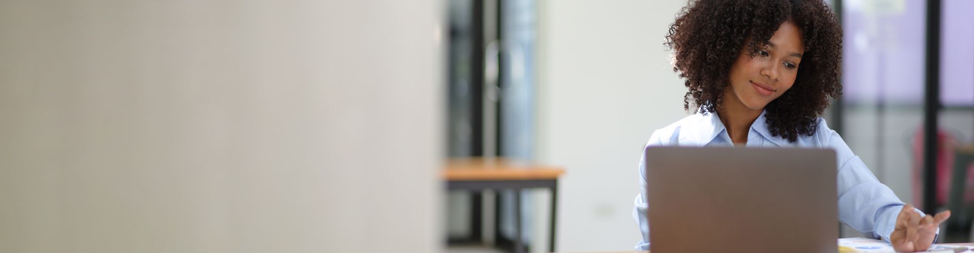 Woman smiling and looking at her laptop