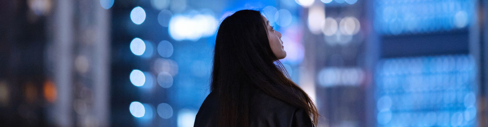 Woman looking up at buildings