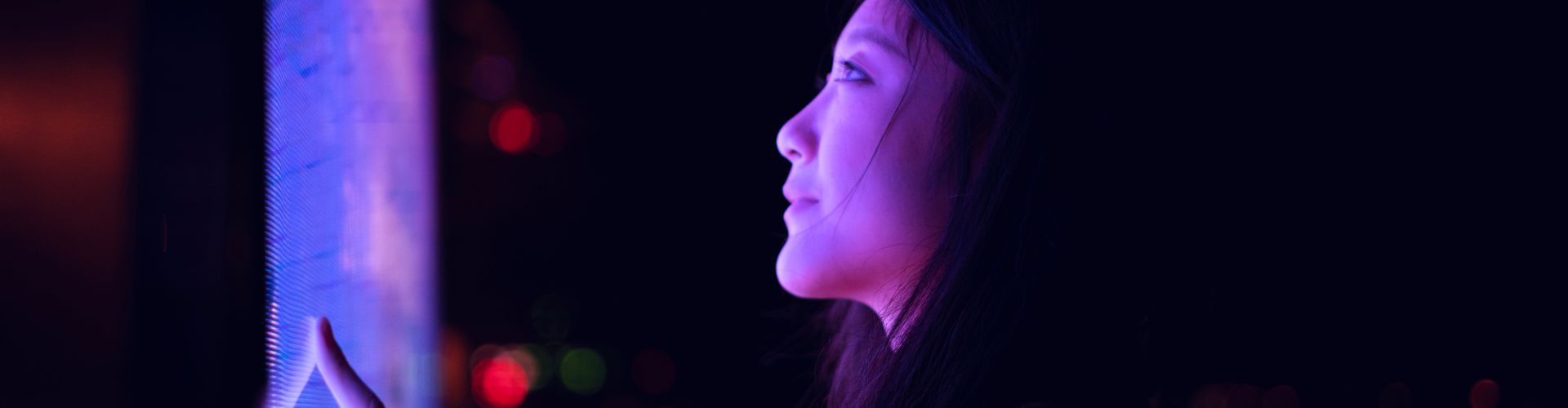 Woman looking at a purple screen