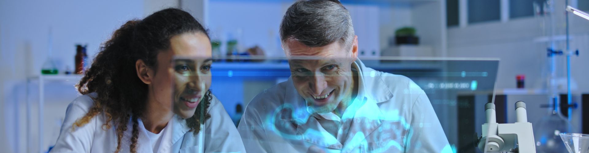 Two people in front of screen