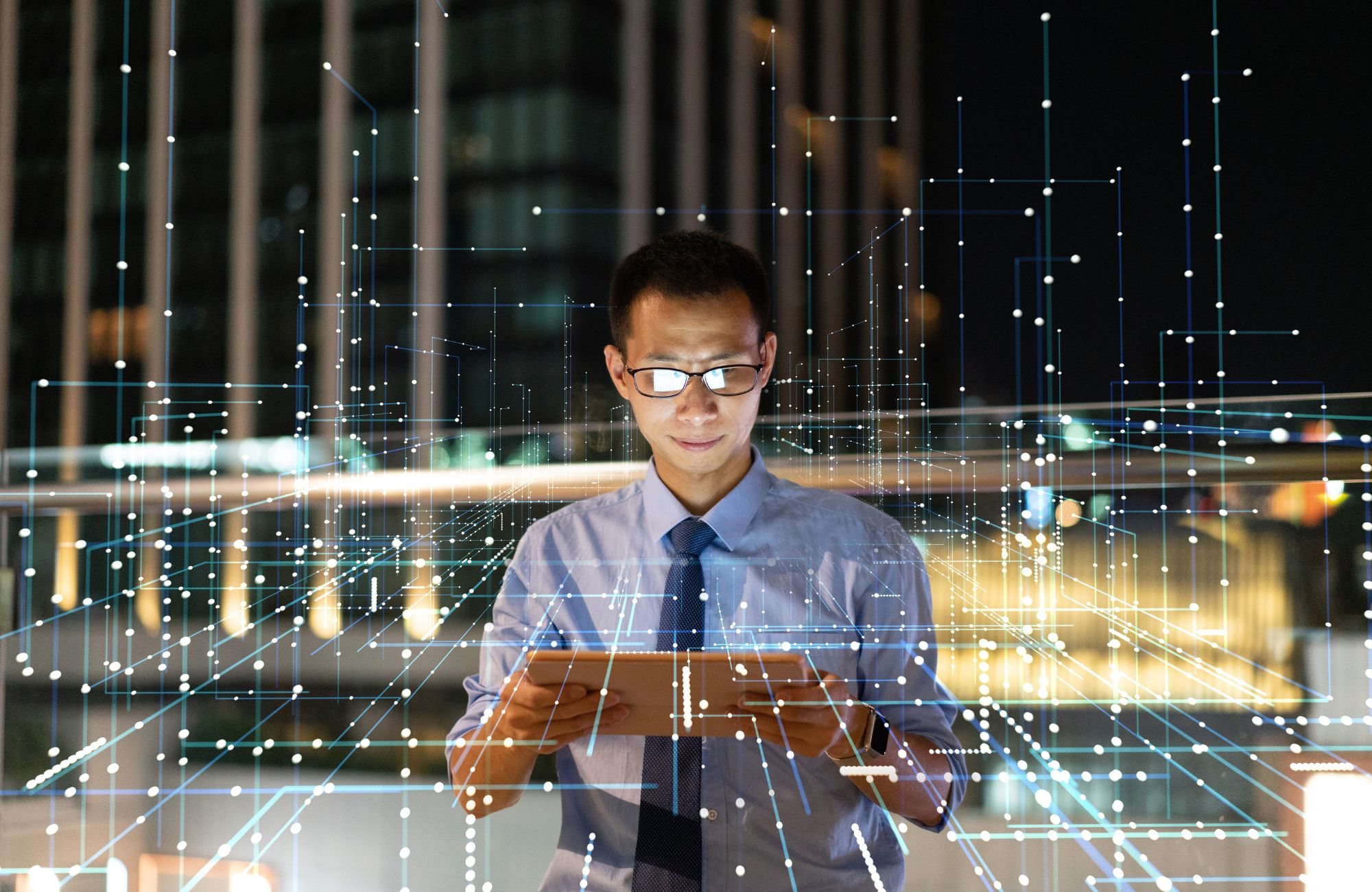 Businessman looking at ipad surrounded by lines representing payments architecture