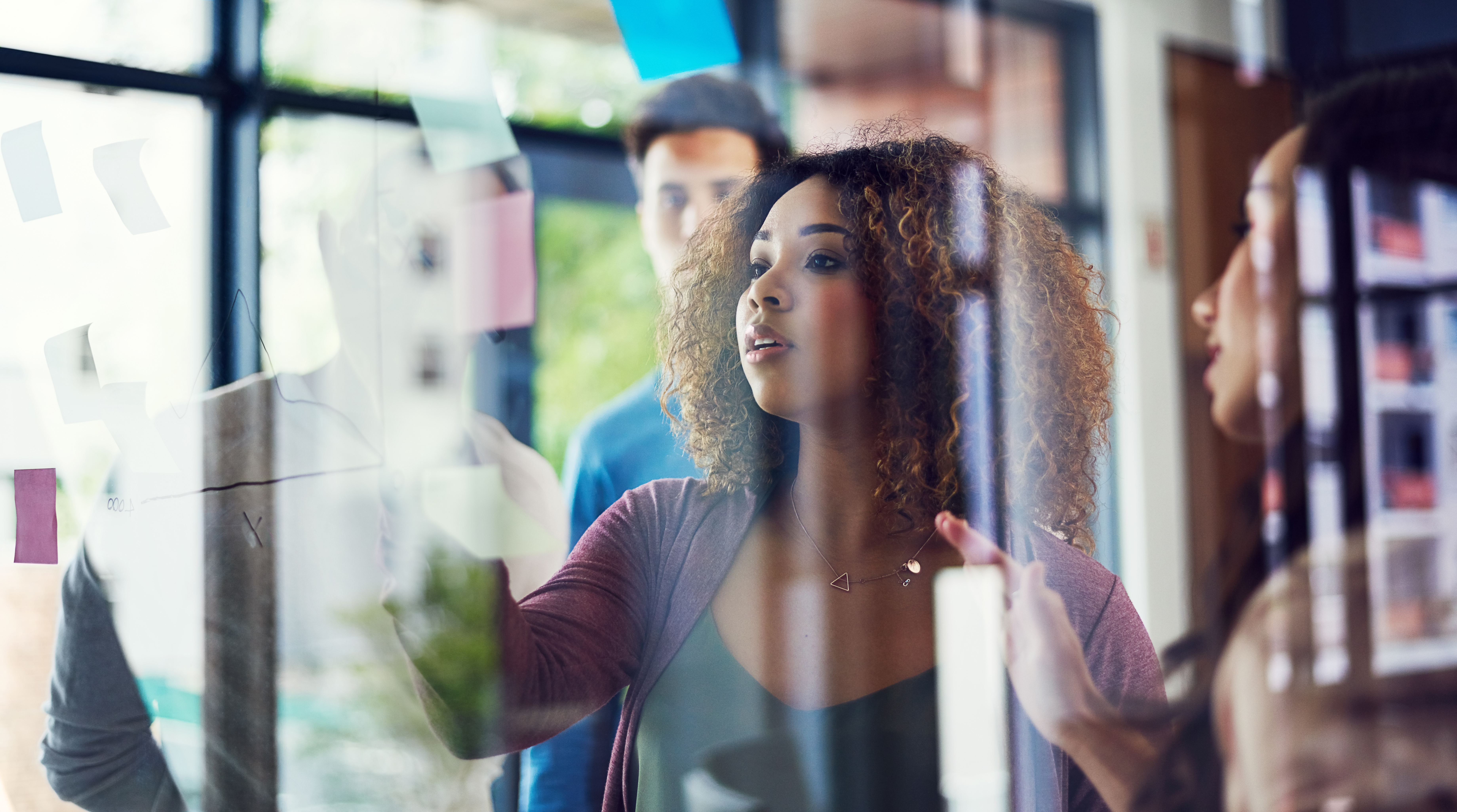 Team looking at post-it notes