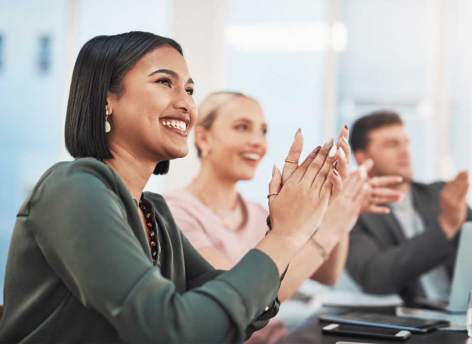 Shot of a group of businesspeople clapping during a meeting in a modern office