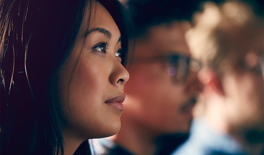 A young Asian professional watches presentation
