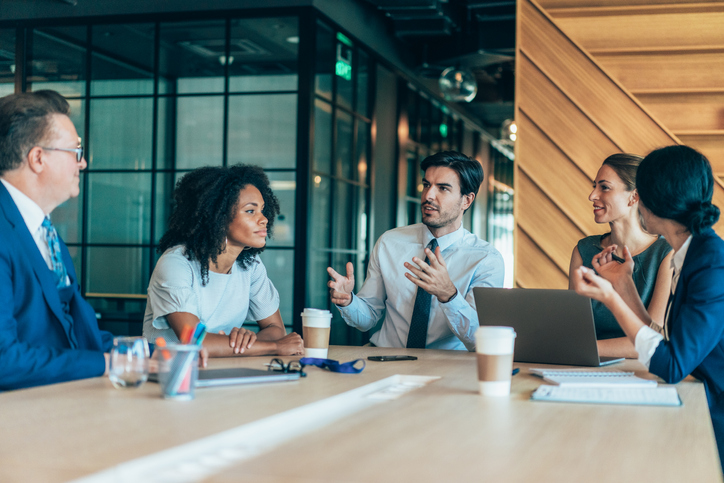 Group of business people talking around the conference table