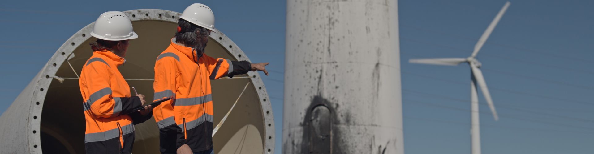 Two people fixing a wind turbine 
