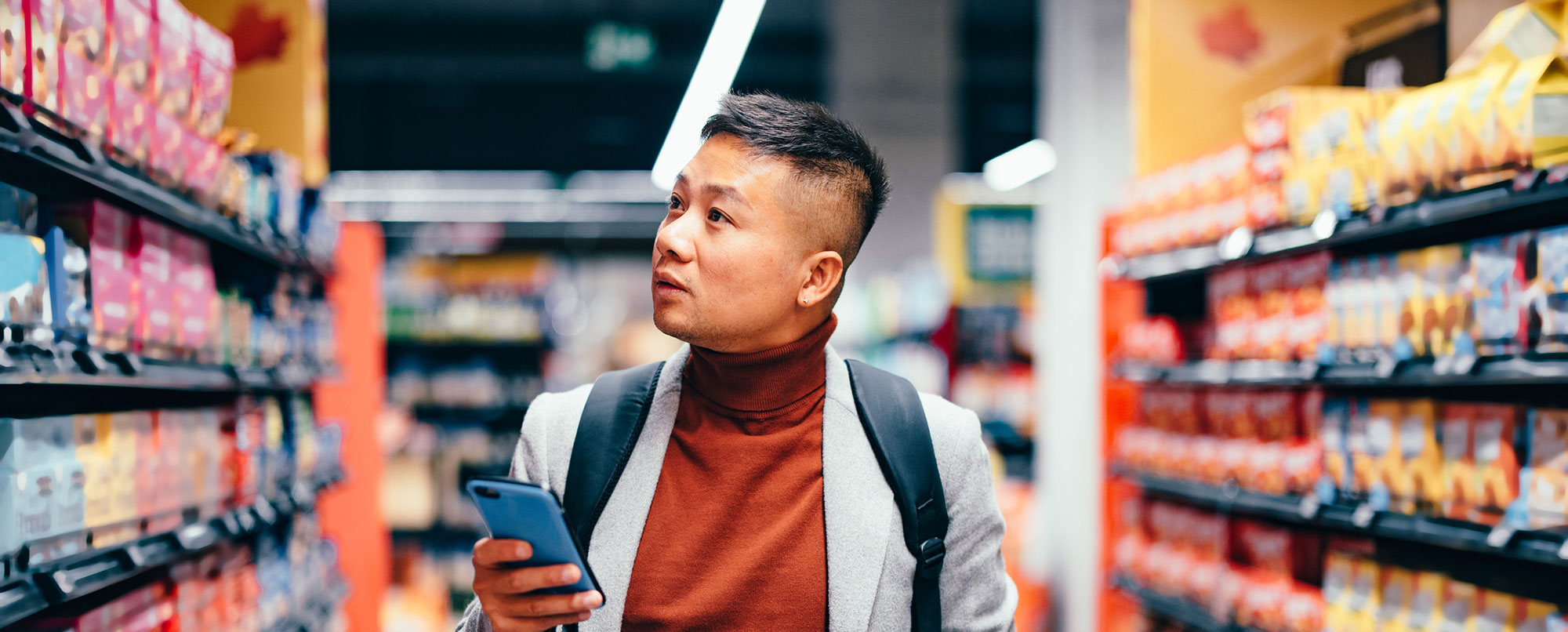 Man looking at shelves in a supermarket