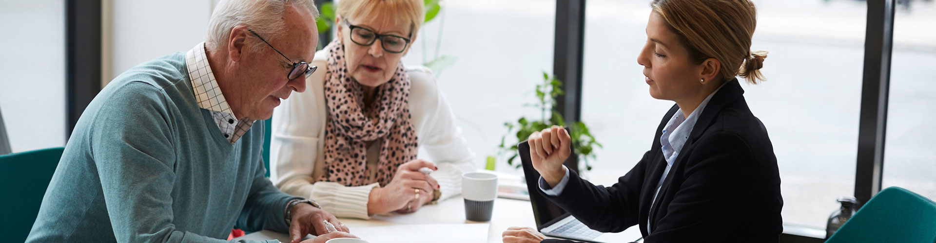 Middle aged couple going through a contract with an insurer