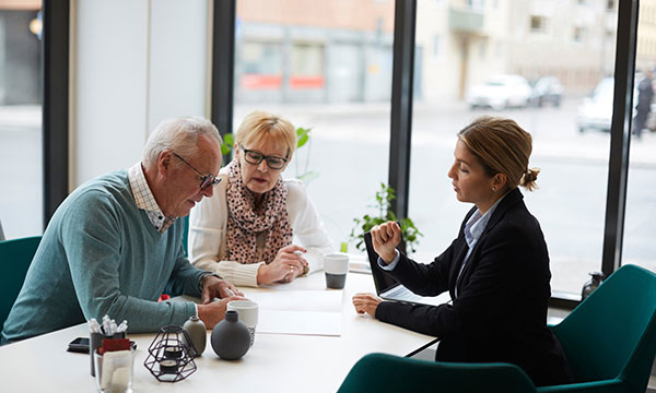 Middle aged couple going through a contract with an insurer