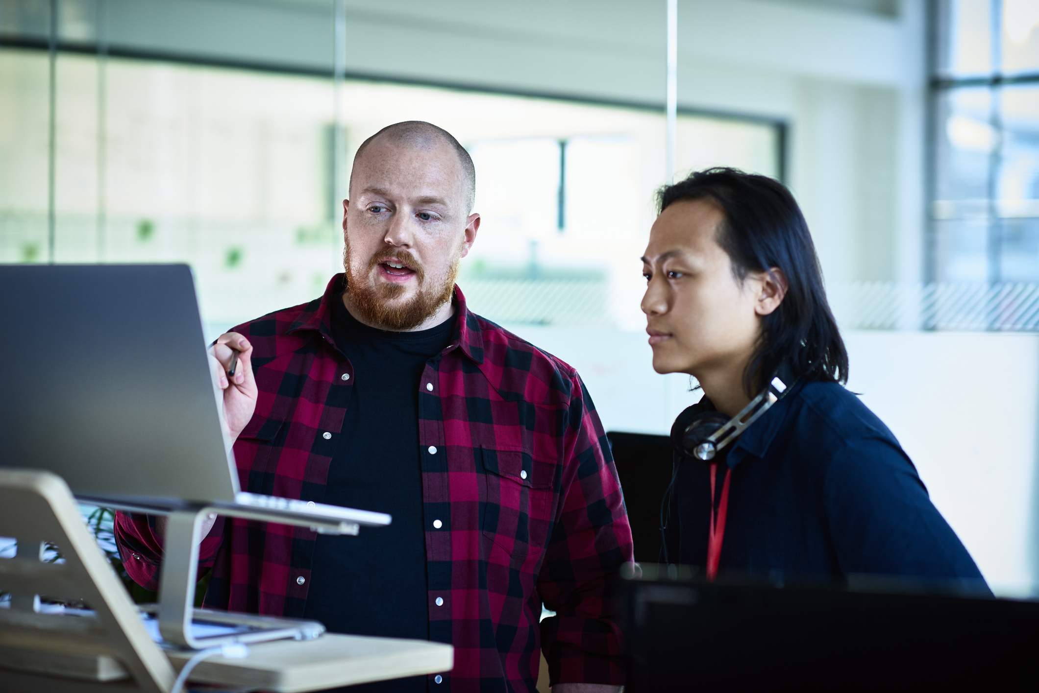 Two colleagues looking at a screen and having a discussion