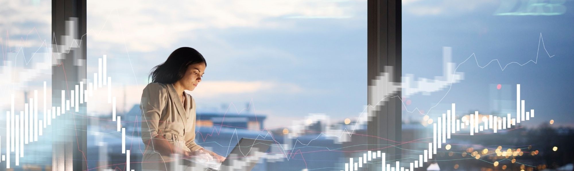 Financial specialist working on laptop with city skyline behind her and graphs surrounding her