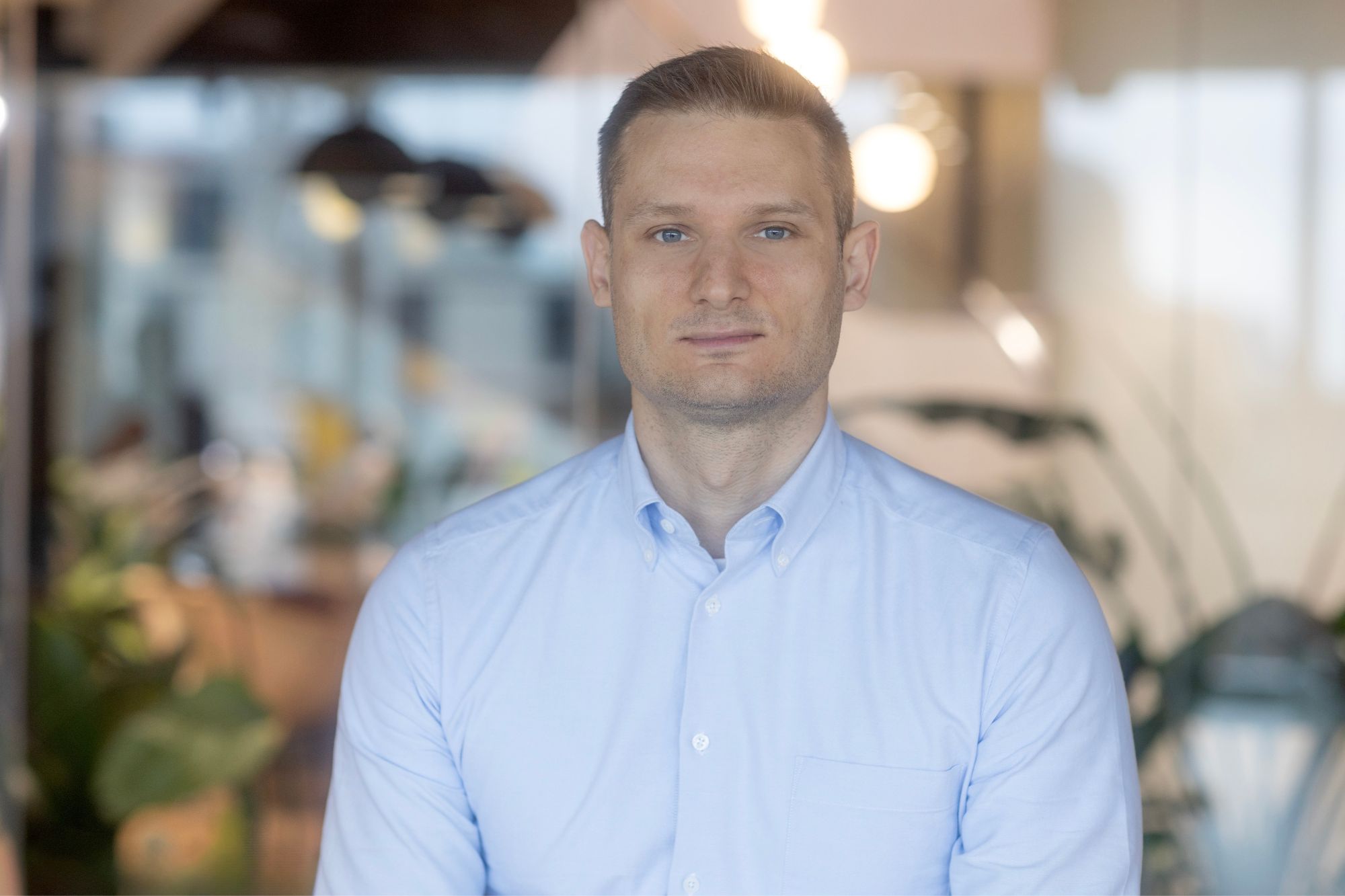 A professional headshot of Alex Spencer