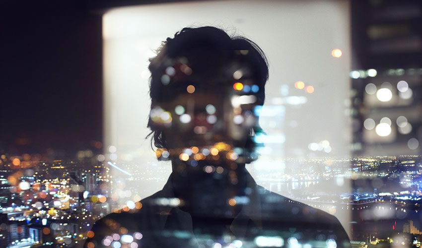 Silhouette of business man against city