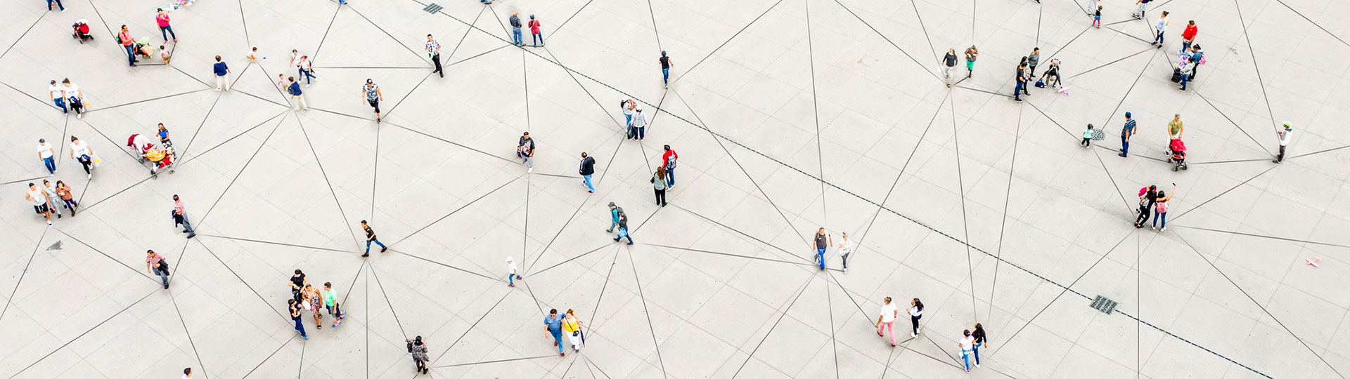 An aerial view of people walking over a triangular-patterned surface