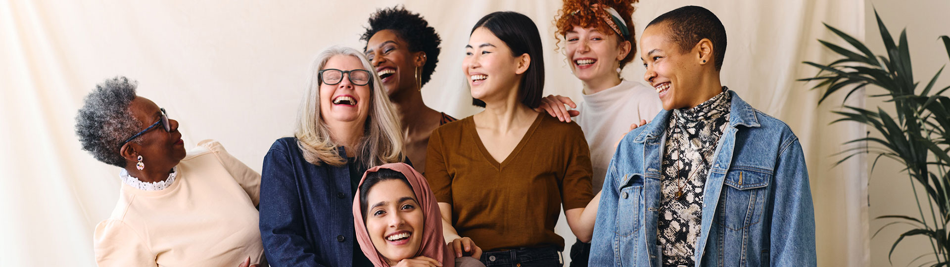 A diverse group of women laughing and smiling
