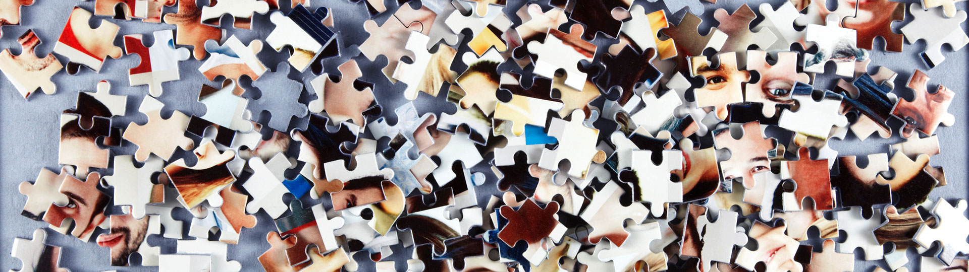 Disassembled jigsaw pieces showing aspects of the human face