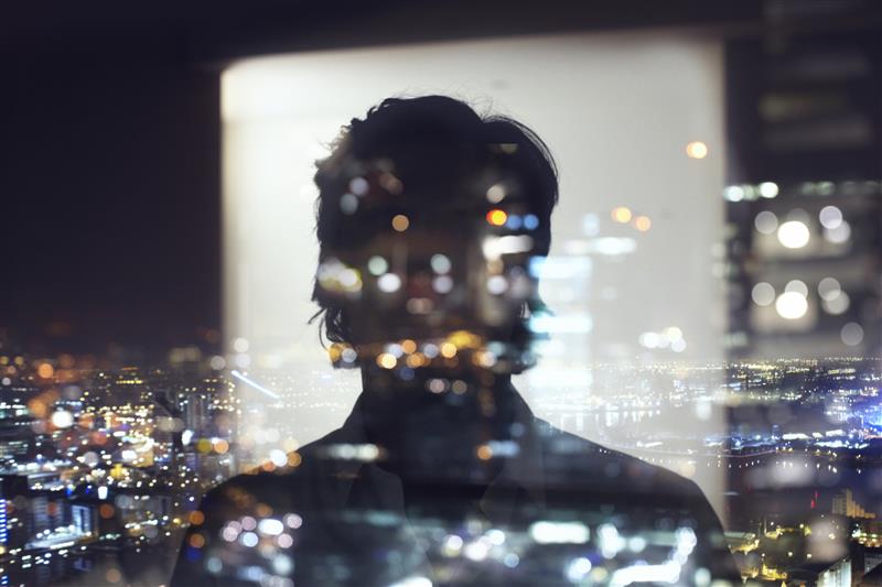 Silhouette of business man against city