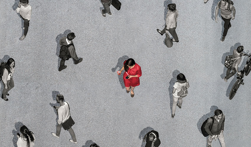 Woman walking among other people