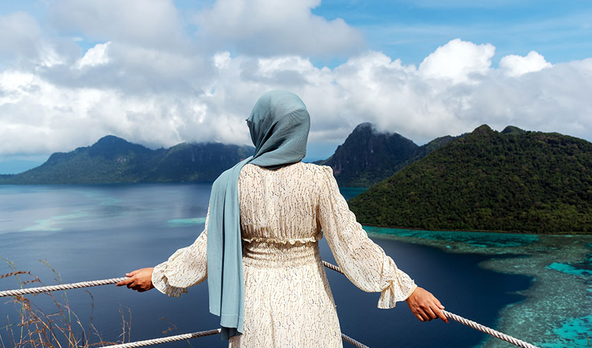 Woman Looking Over Beautiful View of an Ocean in Bohey Dulang