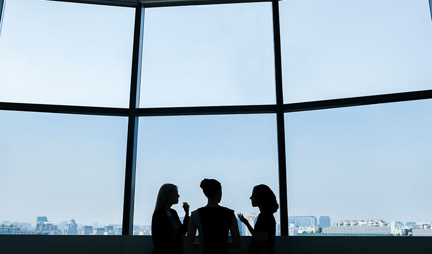 Group of women having a conversation in an office