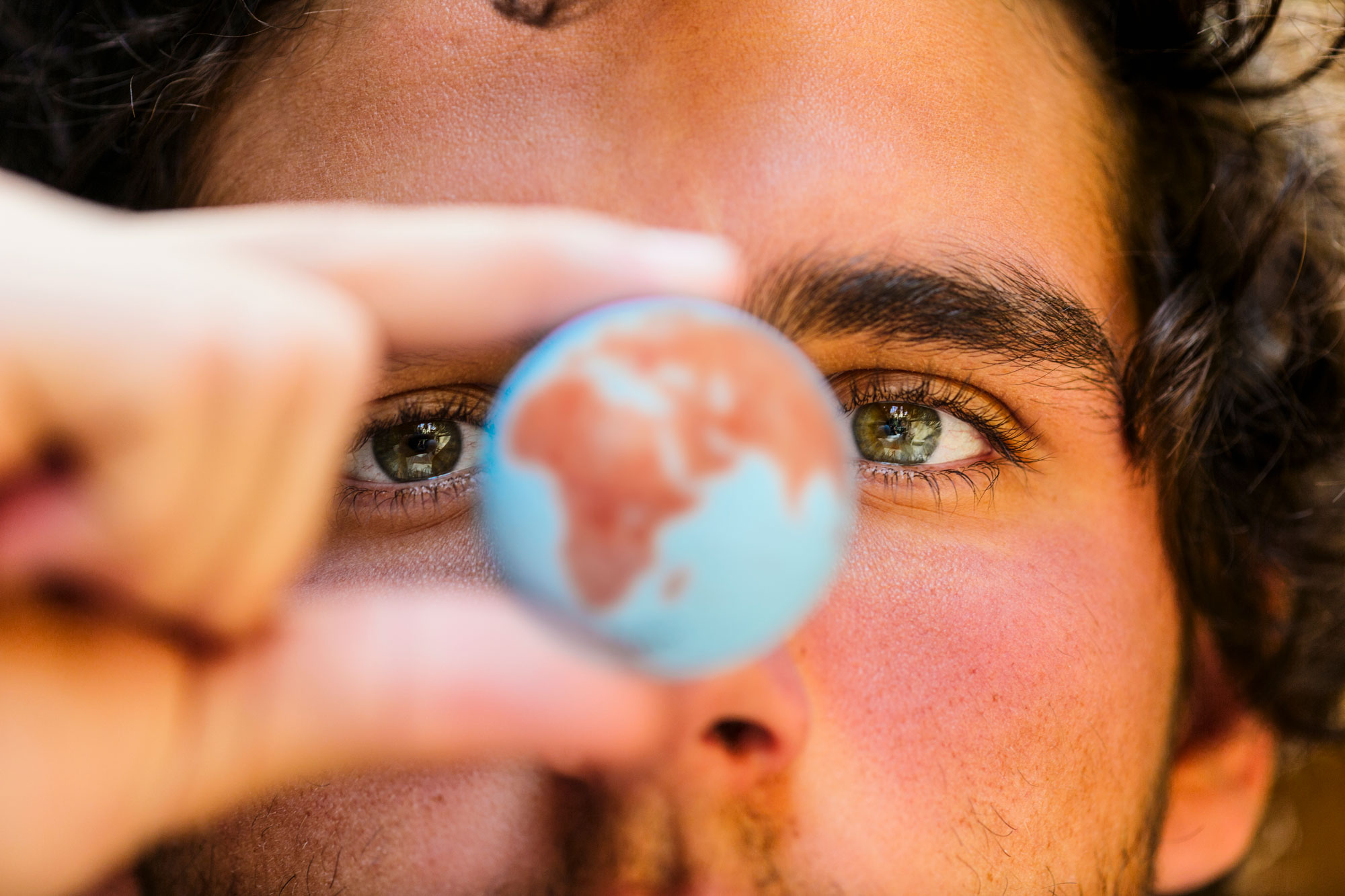 Close up view of a man holding a globe