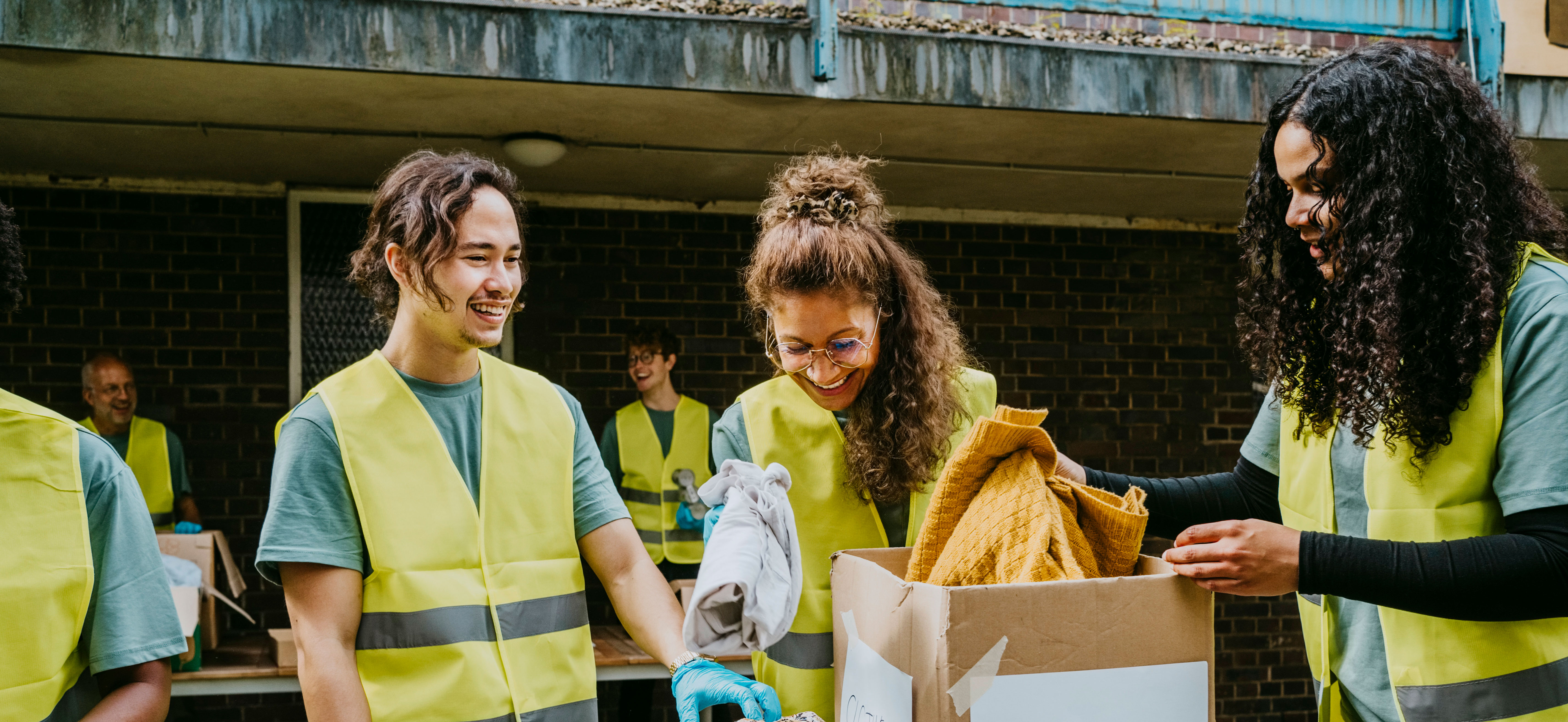 Group of volunteers sorting through donated clothes