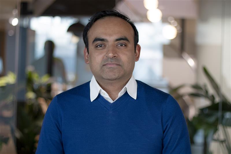 A professional headshot of Deb Mukherjee