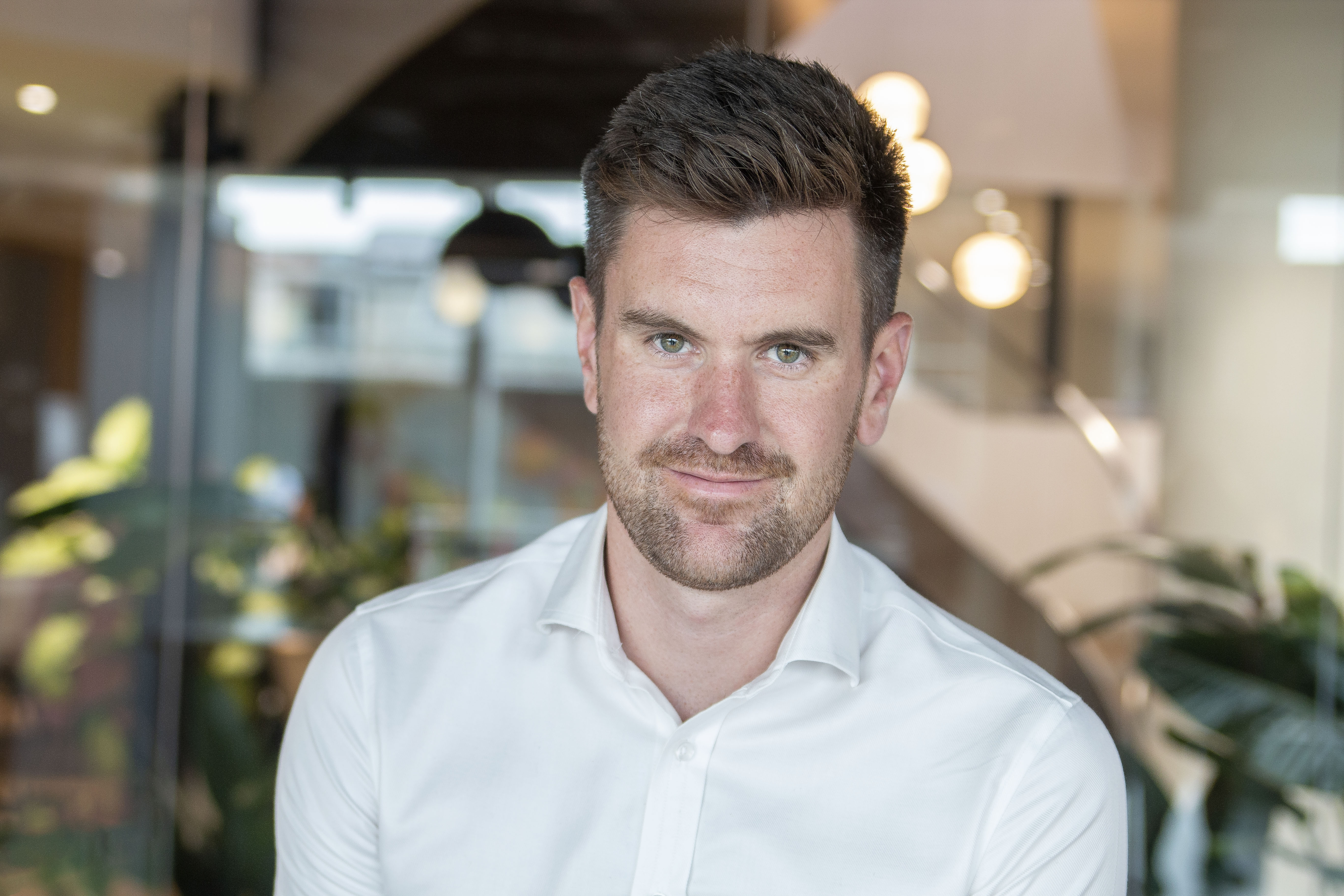 A professional headshot of Sam Mason