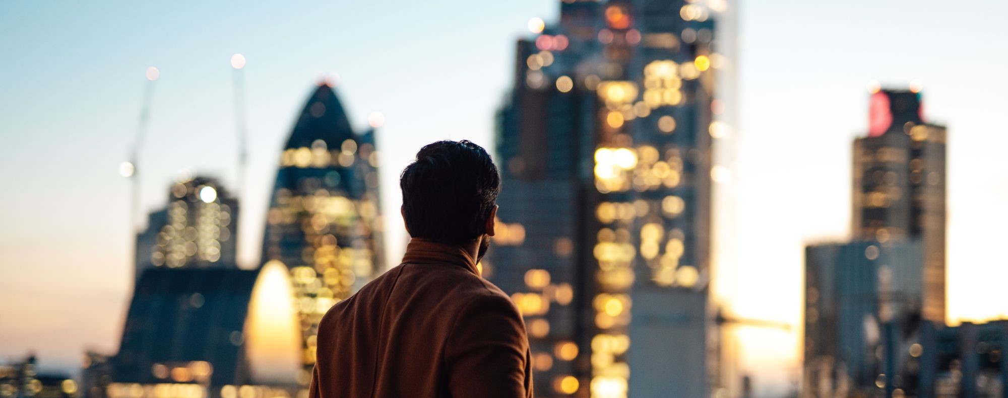 Man looking out at London skyline