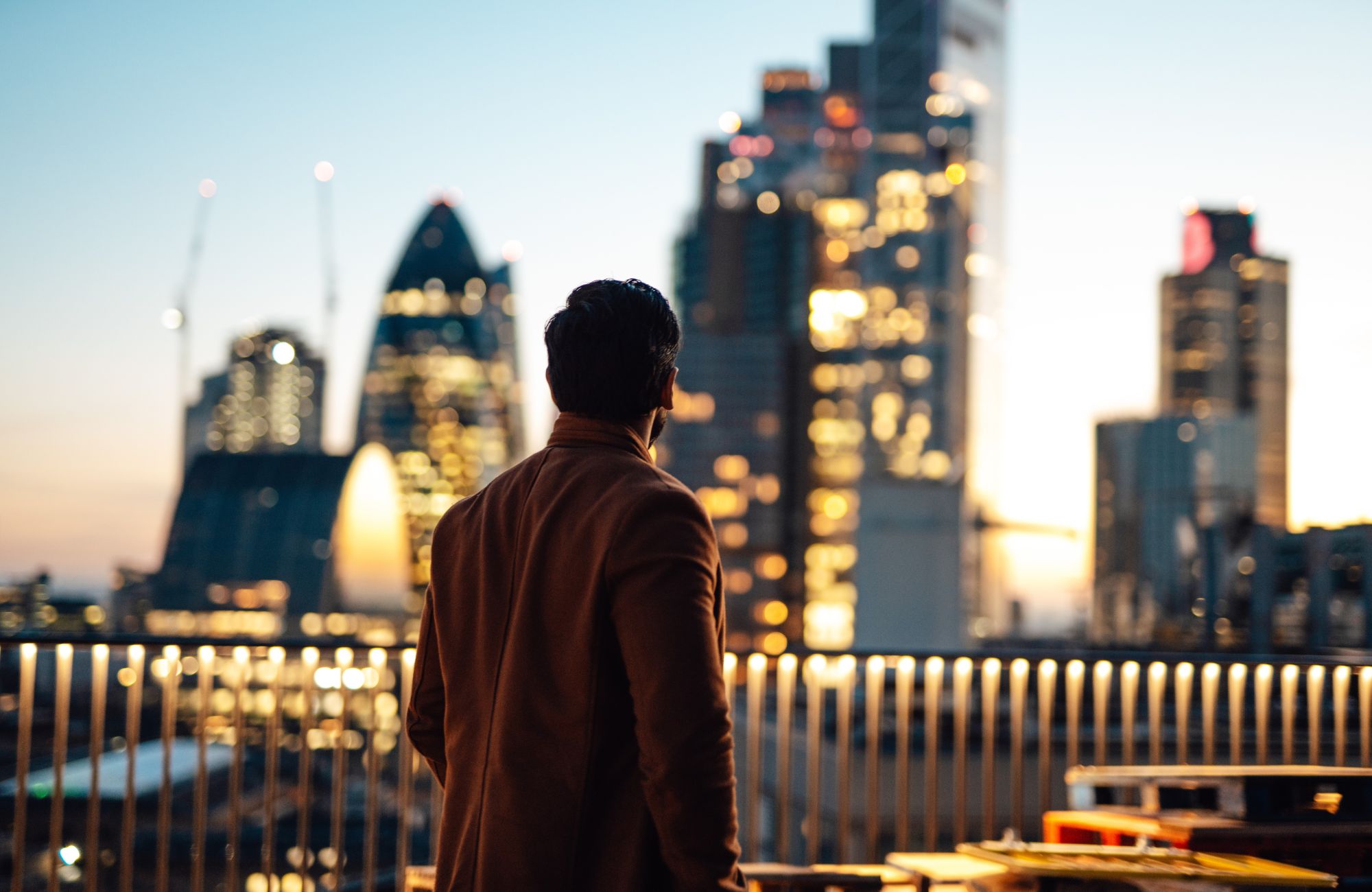 Man looking out at London skyline