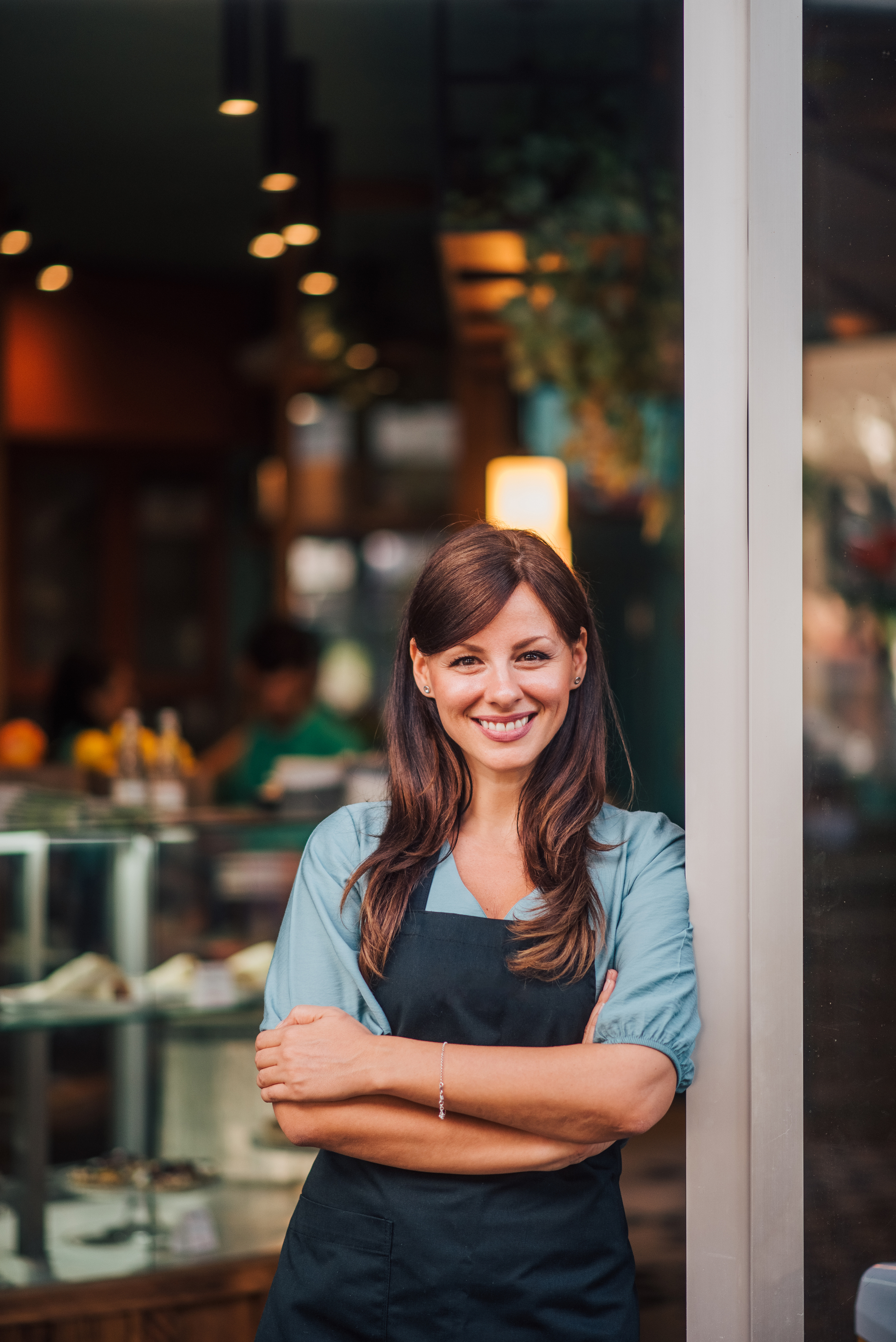 Waitress smiling outside a cafe