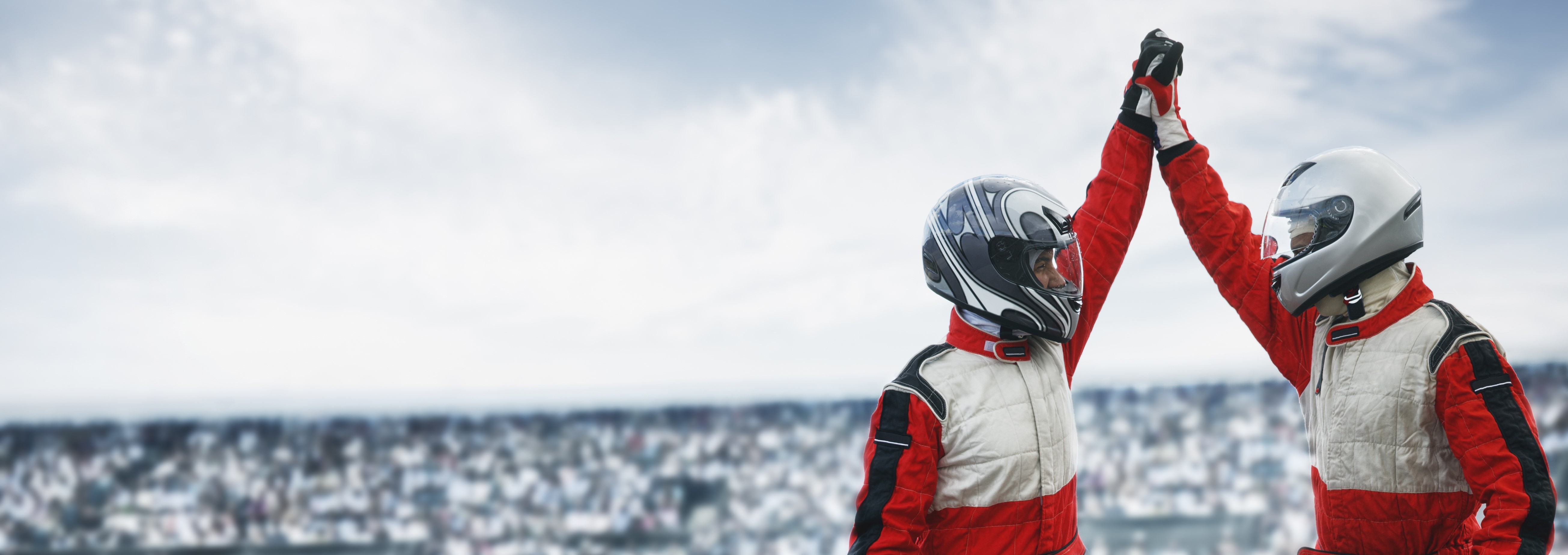 Two racing drivers giving a high five